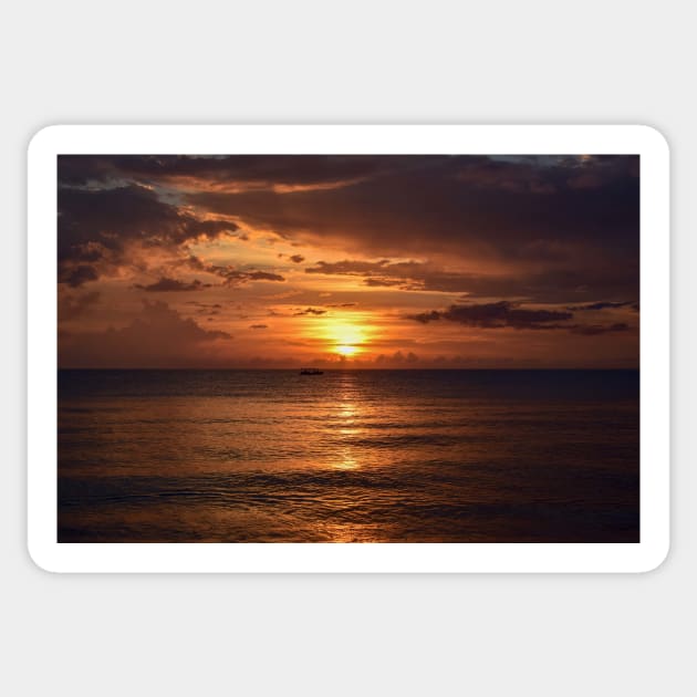 Mesmerizing vertical shot of the sun setting behind the clouds over the calm ocean Sticker by Ryansnow876